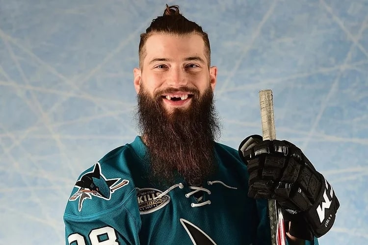 A picture of a hockey player with his hockey stick