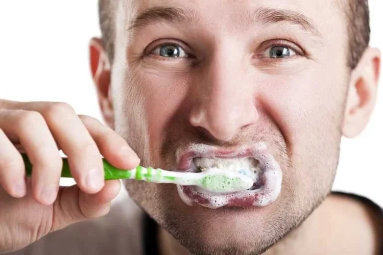 A picture of a man brushing his teeth